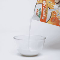 KLF Coconad Coconut Milk for Coffee, Tea, and Breakfast 110 ml — product being poured
